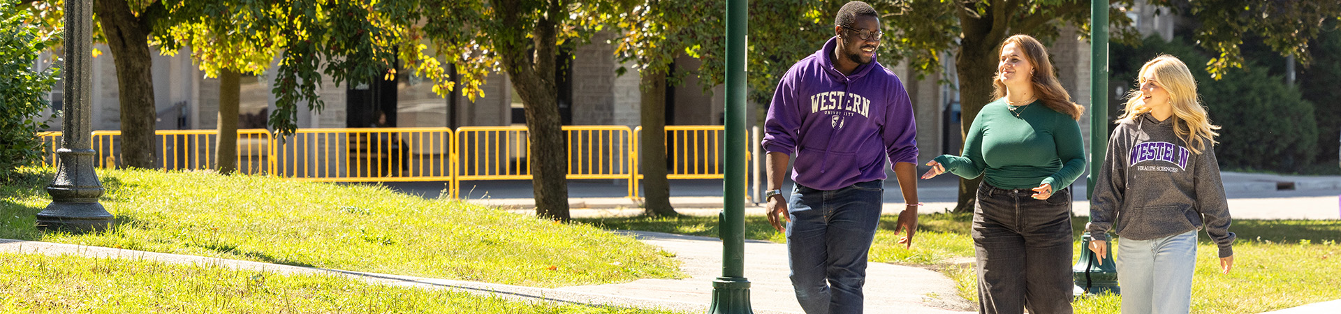 Health Studies students holding their hands up to make "W"s