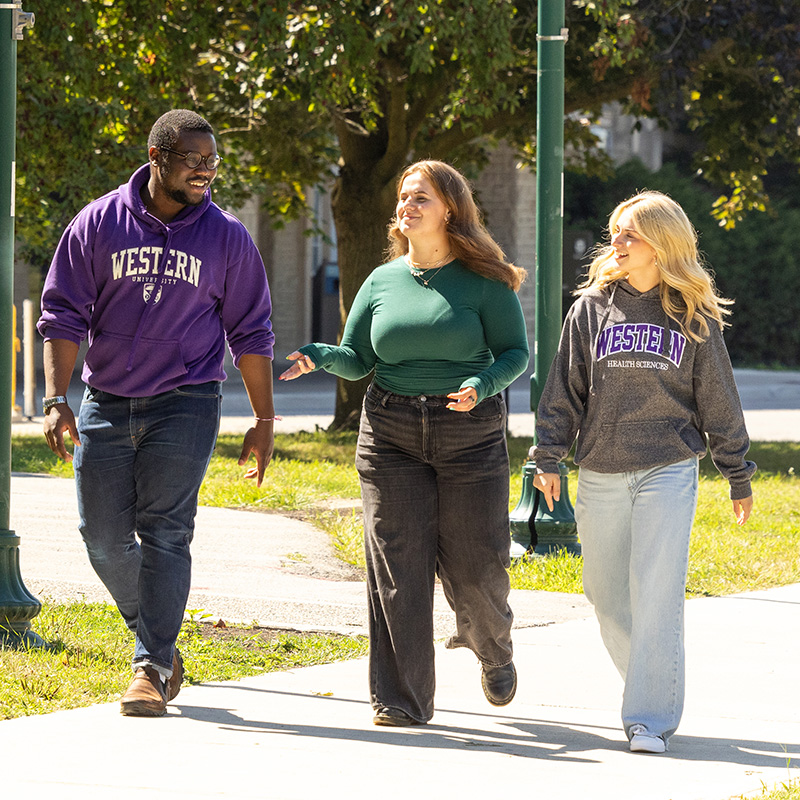 Health Studies students holding their hands up to make "W"s