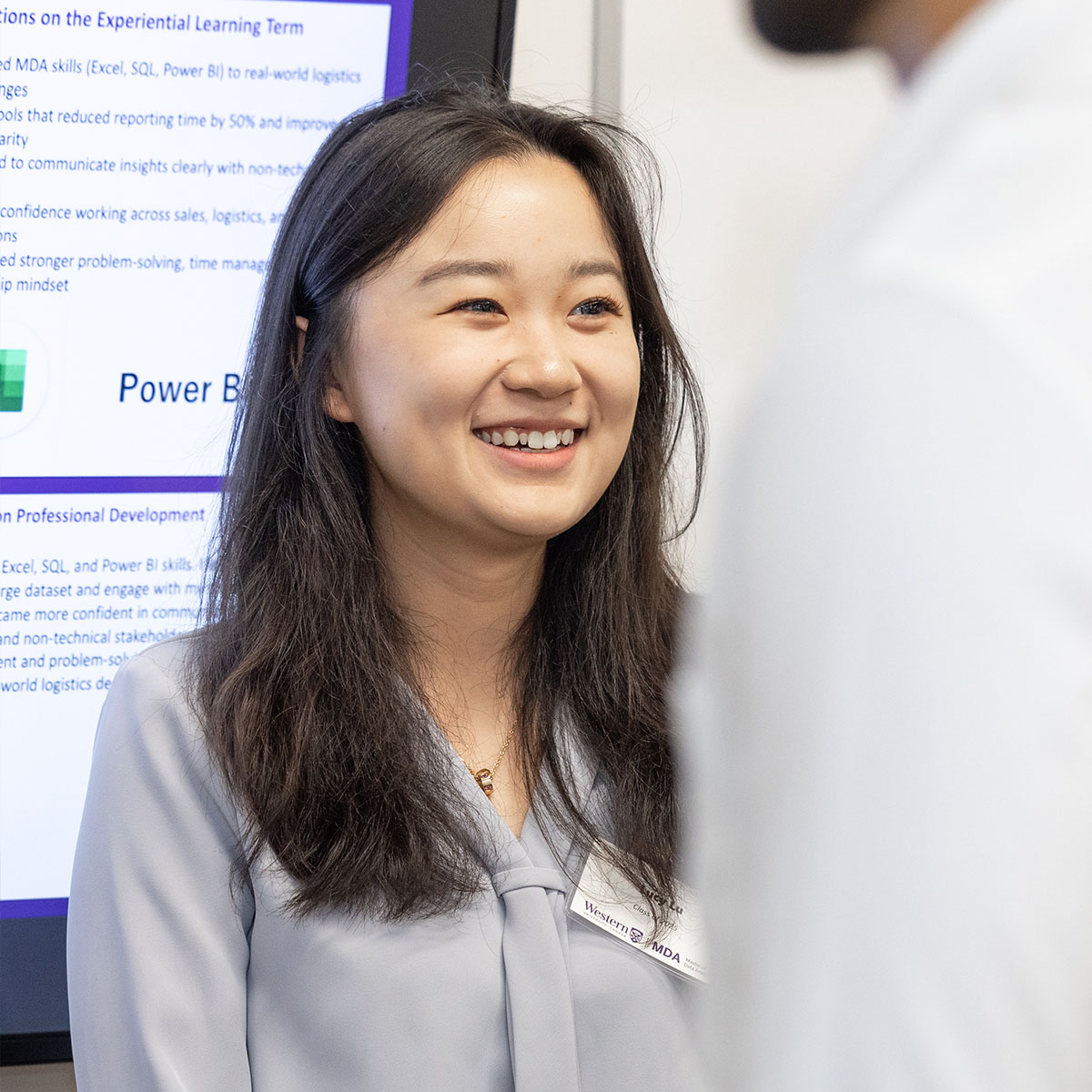 Student smiling looking away