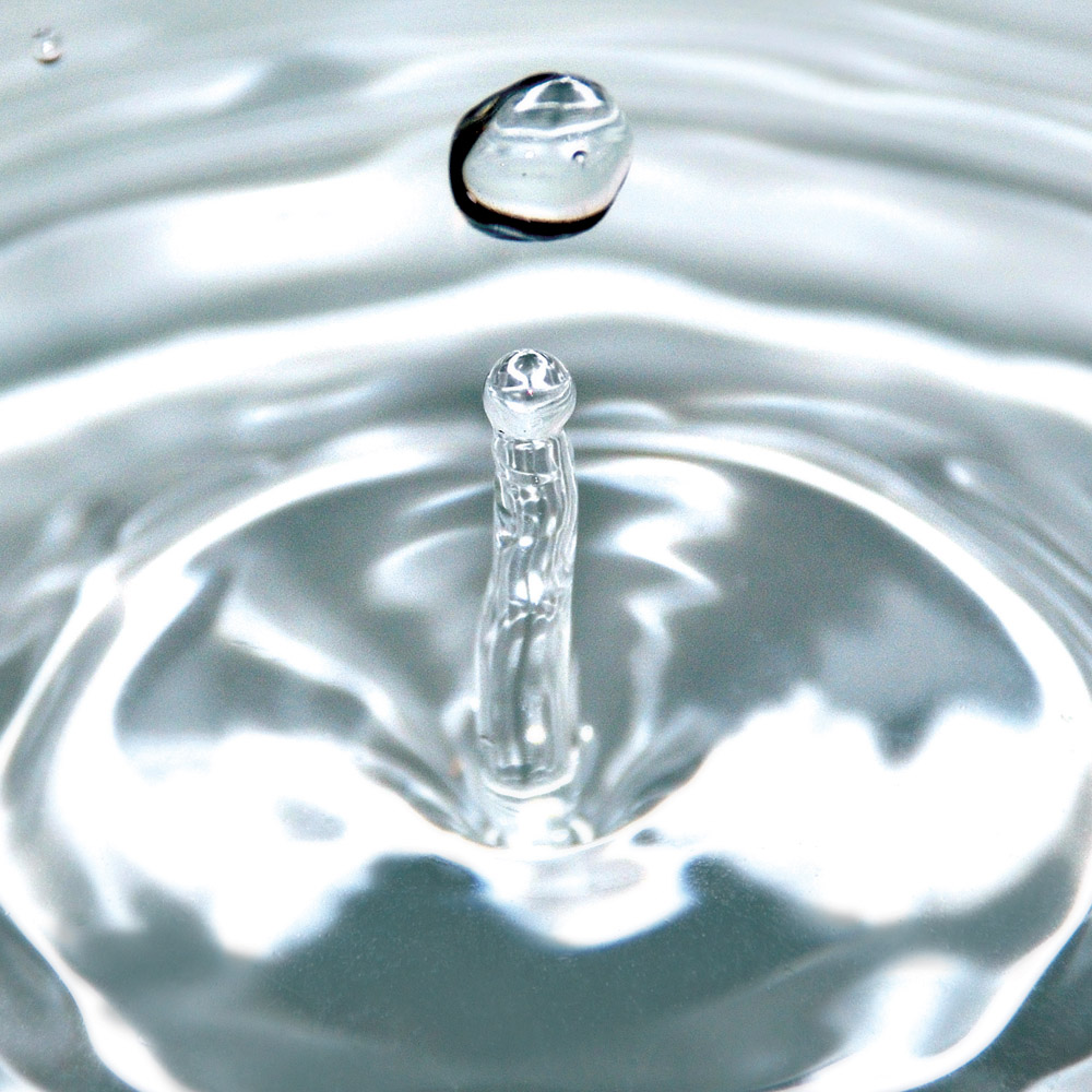 A photograph of a drop of water.