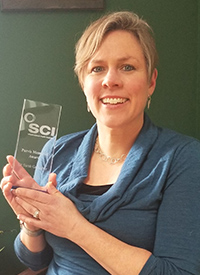 Dr. Sarah Gallagher holding her award