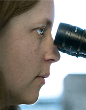 Yolanda Hedberg looking through microscope