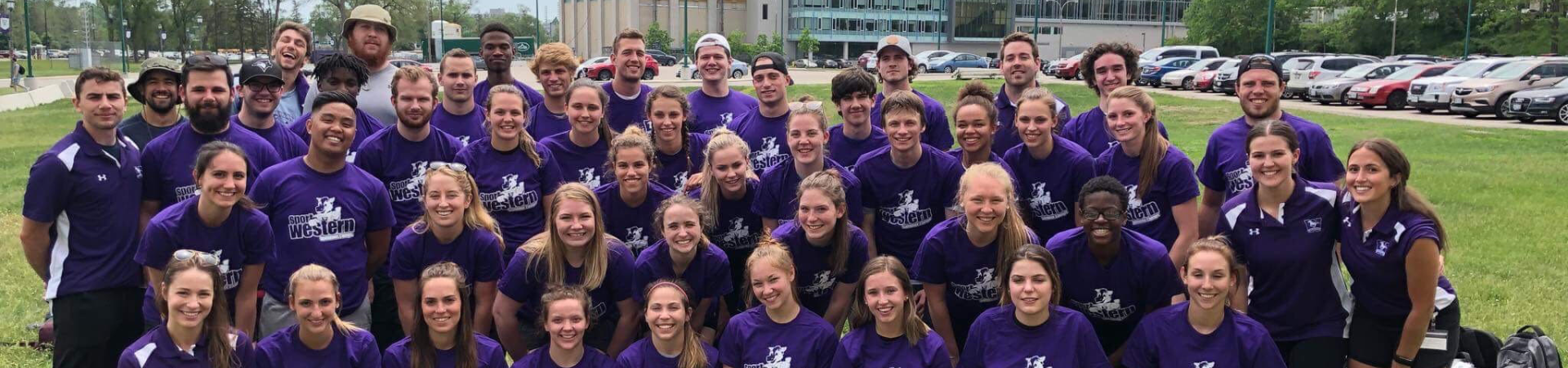 A gathering of student workers wearing purple.