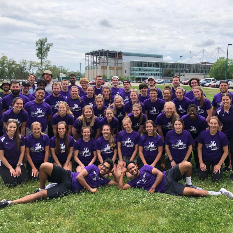 A gathering of student workers wearing purple.