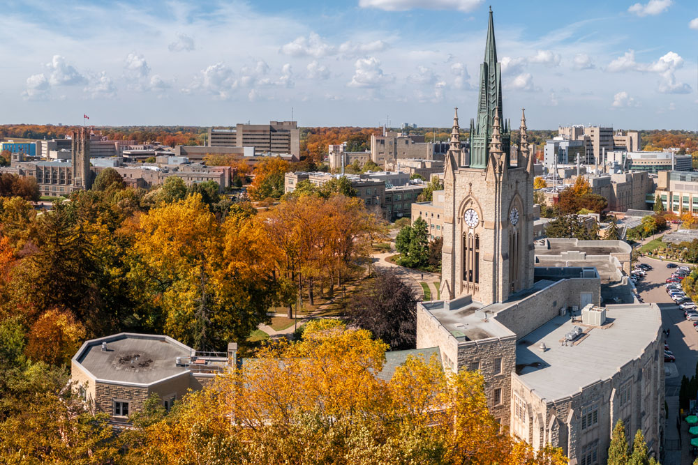 Aerial of Middlesex College surrounded by bright orange Fall folliage.