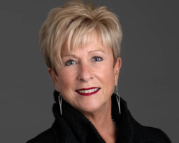 Headshot of Lynn Logan wearing black