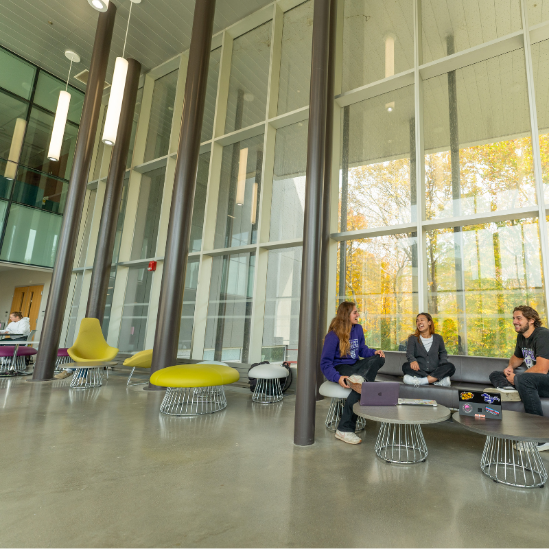 Students talking around a table in the WIRB lobby