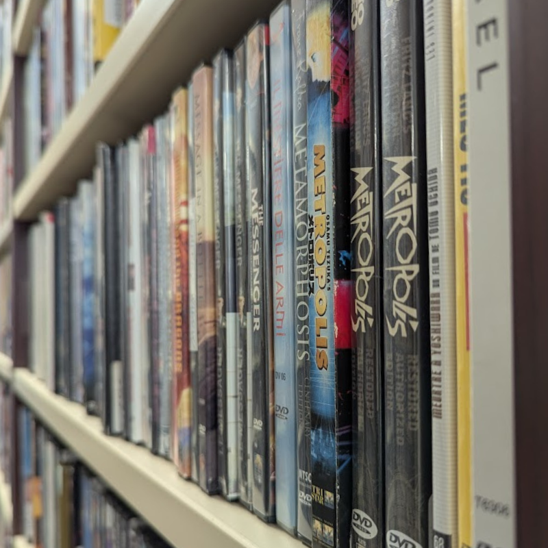 A shelf with a row of DVDs