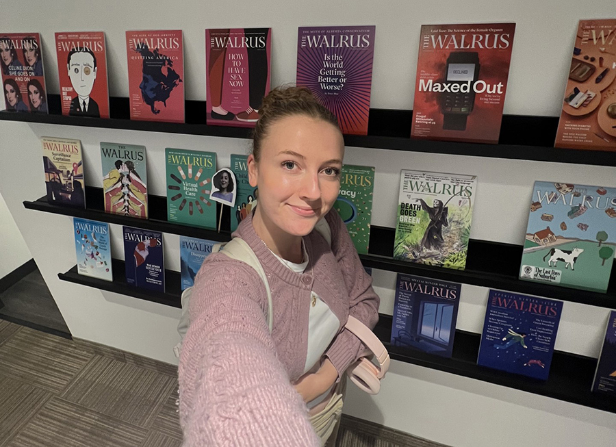 A student stands in front of a display of Walrus magazines at the Walrus Offices in Toronto