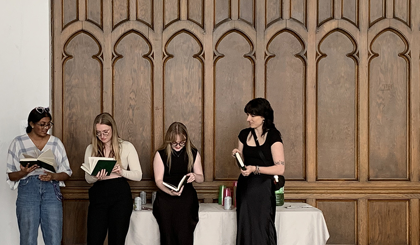 Four students holding books at a SASAH celebration