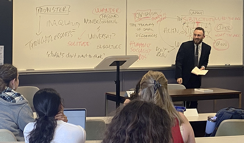 An instructor in front of a white board