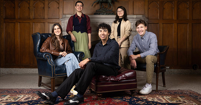 Five students stand together 