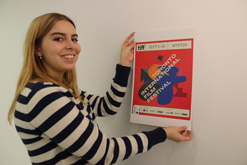 SASAH student Catherine Cassels holds a printed poster