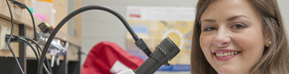 Close up of student at a microscope banner