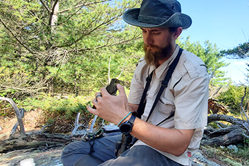 Person holding bird outside