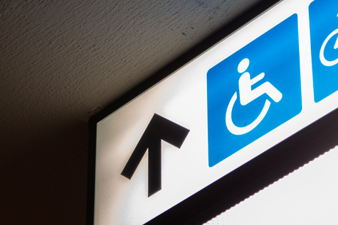 Arrow pointing up with wheelchair symbol beside it