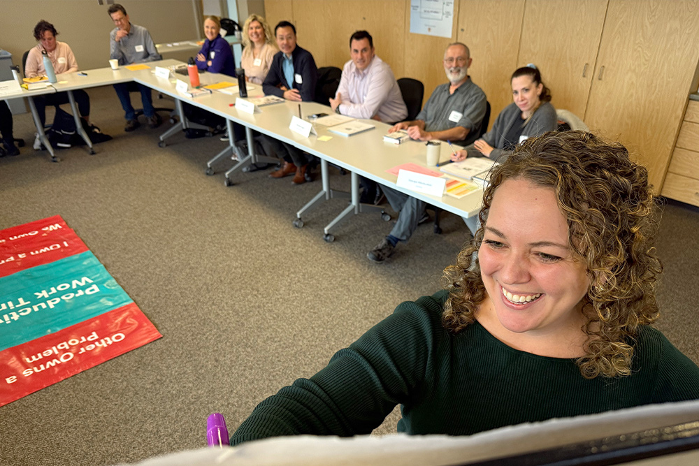 An instructor at a white board during a leadership development course.