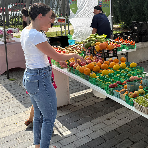 Staff members attend Western's outdoor Farmers Market.