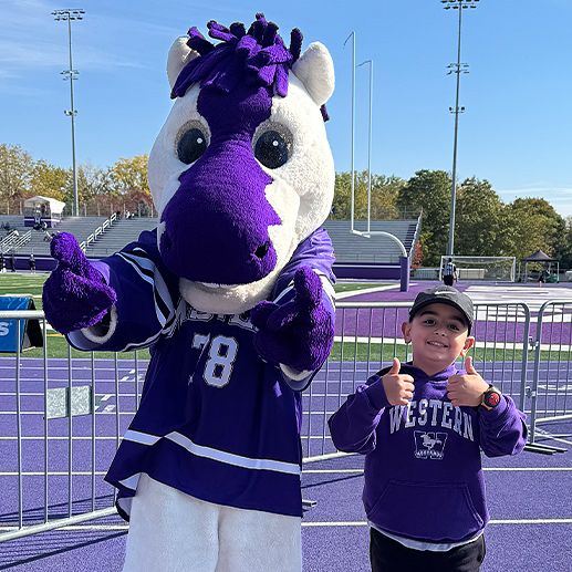 A child and Western's mascot JW.