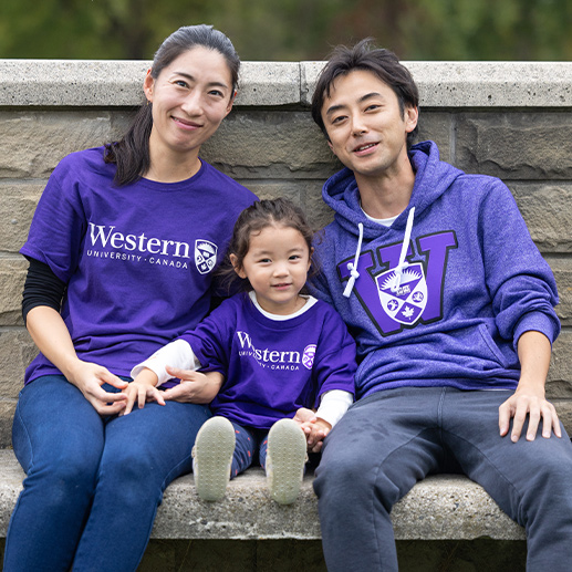 A mother, father and their child at Homecoming.