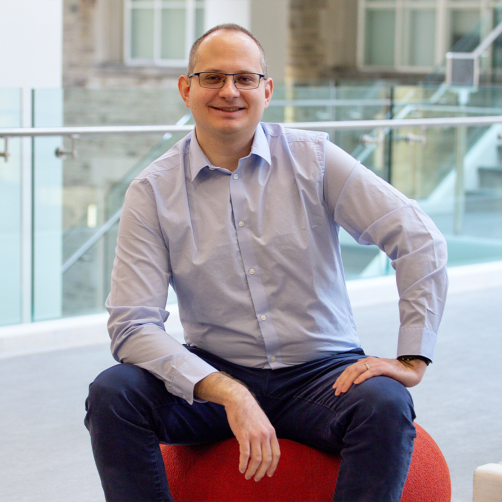 Denis Vida sitting on a stool and looking into the camera.