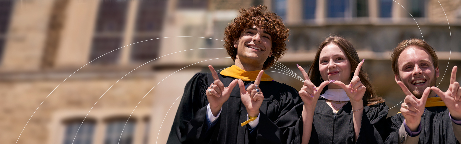 Graduating students from Western University throwing the W hand sign