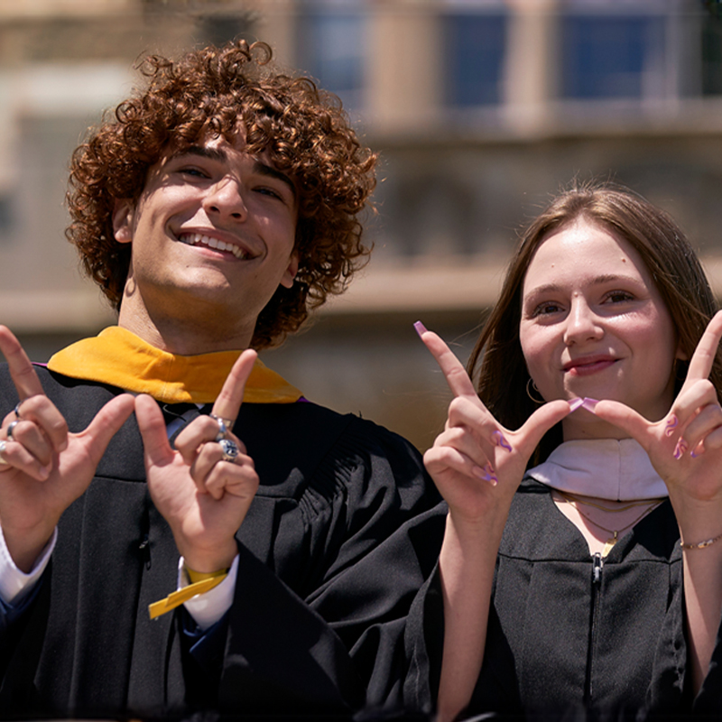 Graduating students from Western University throwing the W hand sign