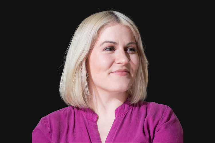 Headshot of Becca Lewis on a black background