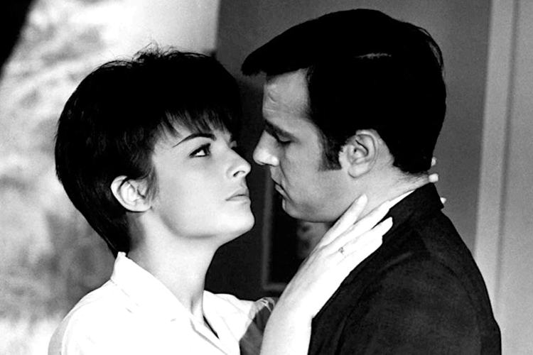 Black and white TV show image of two actors about to kiss