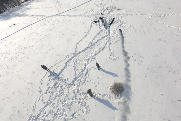 Documentation of artists Andrew Maize and Lisa Hirmer experimenting with kites and smoke bombs