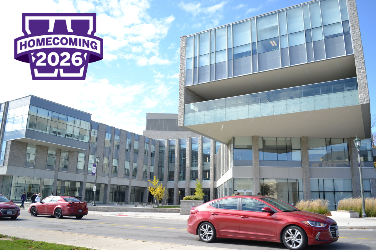 Exterior photo of the FIMS & Nursing Building with the Homecoming 2026 logo overlaid in the top right corner