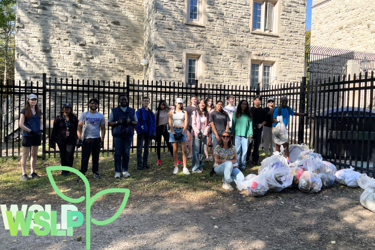 Group of people standing outside after a campus clean-up