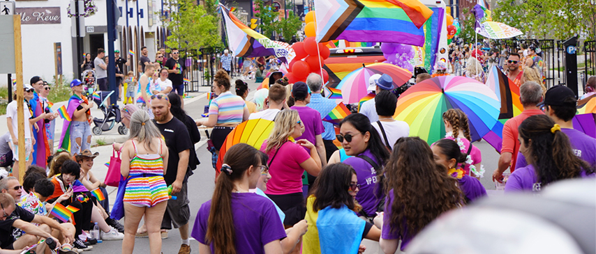 Crowd gathered at the London Pride Parade with Western students at the front