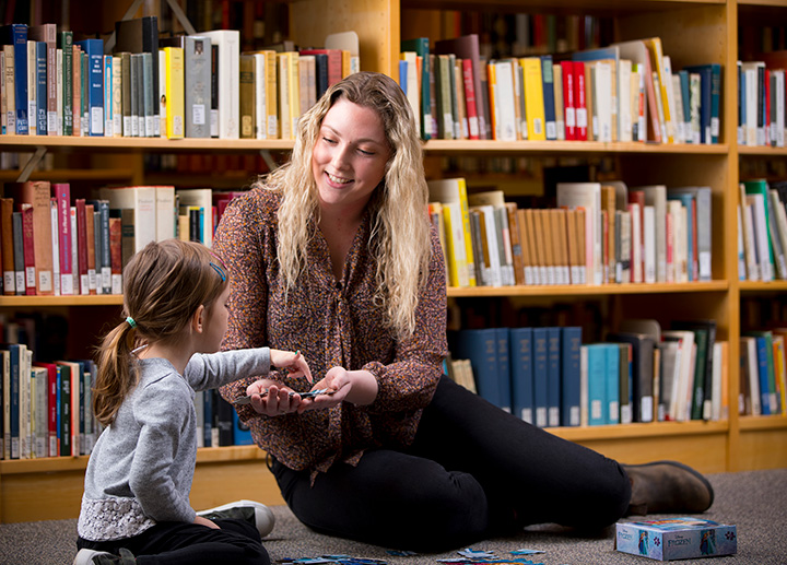 A family studies student working with a child.