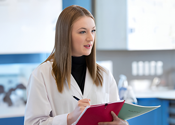 Master of Science in Foods and Nutrition student holding a notebook and pen.