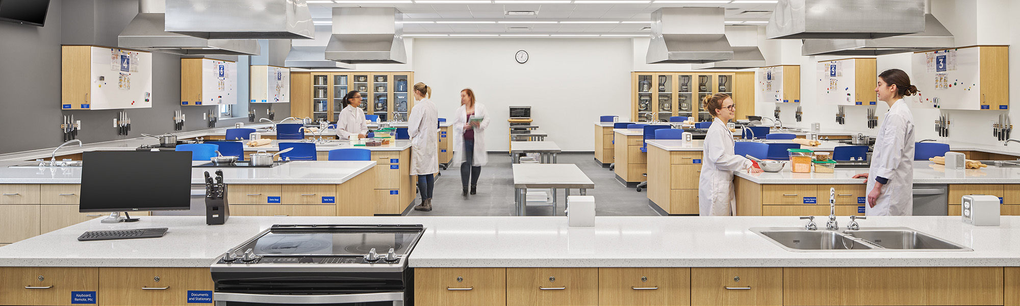 A photo of a food laboratory with students working and talking