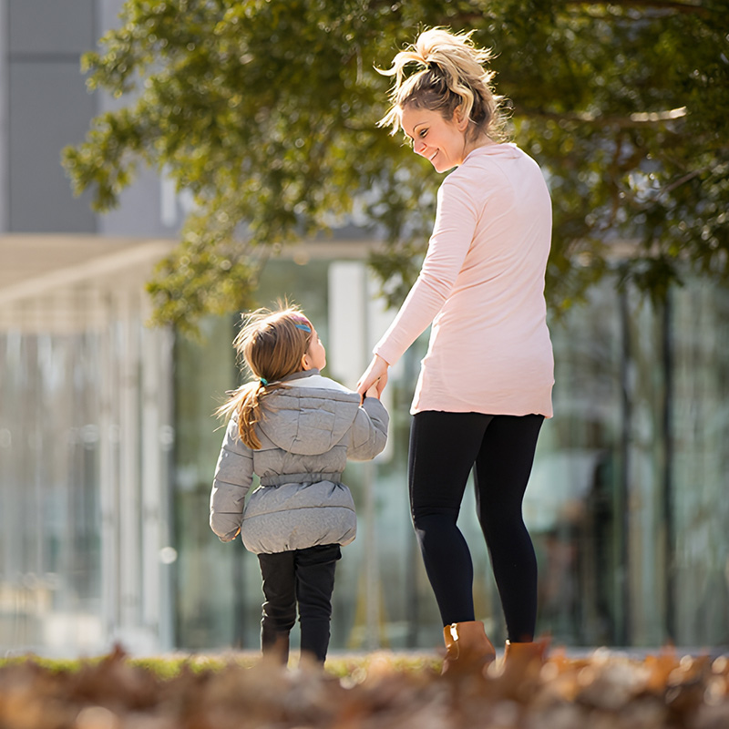 Parent walking with a child on campus