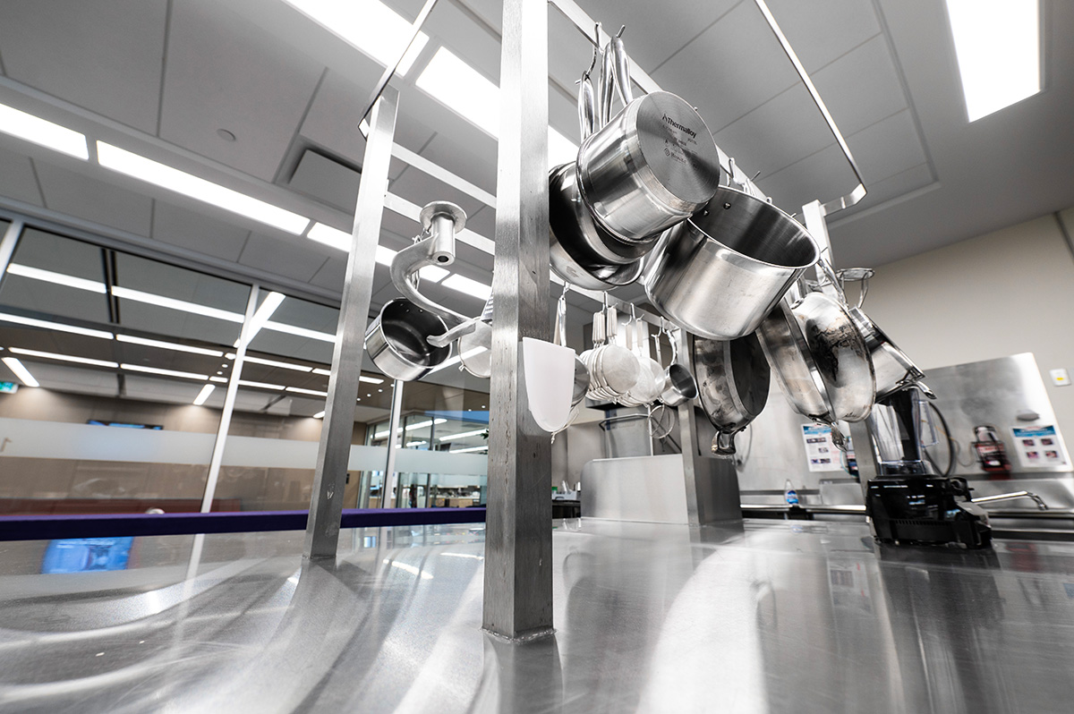 Closeup of pots and pans hanging up in the kitchen.