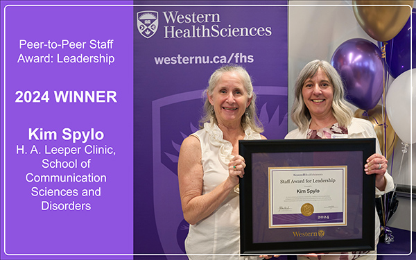 Kim Spylo receives her award from Jayne Garland