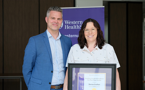 Denise Grafton receives her award from Shaun Boe, Dean