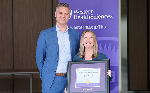 Katie Powell receives her award from Shaun Boe, Dean