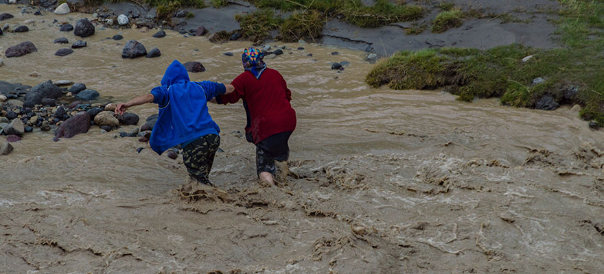 People walking in flooded river