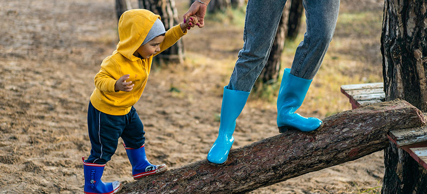 Child playing on a log