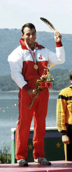 Alwyn Morris raises an eagle feather on the podium of the 1984 Summer Olympics