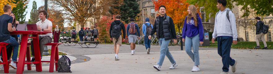 students walking across campus on a colourful fall day