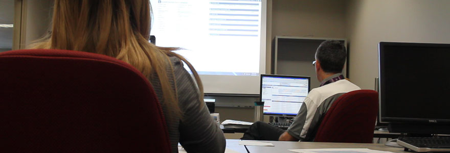 Two people in a computer lab taking training