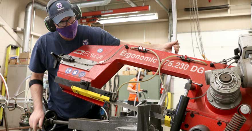 FM tradesperson cutting the metal frame to size for barriers