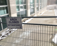 The temporarily restricted walkway along the northwest side of Support Services Building