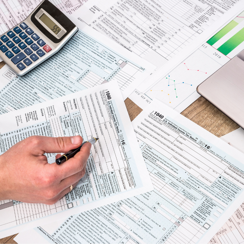 Two people looking at a table covered with papers