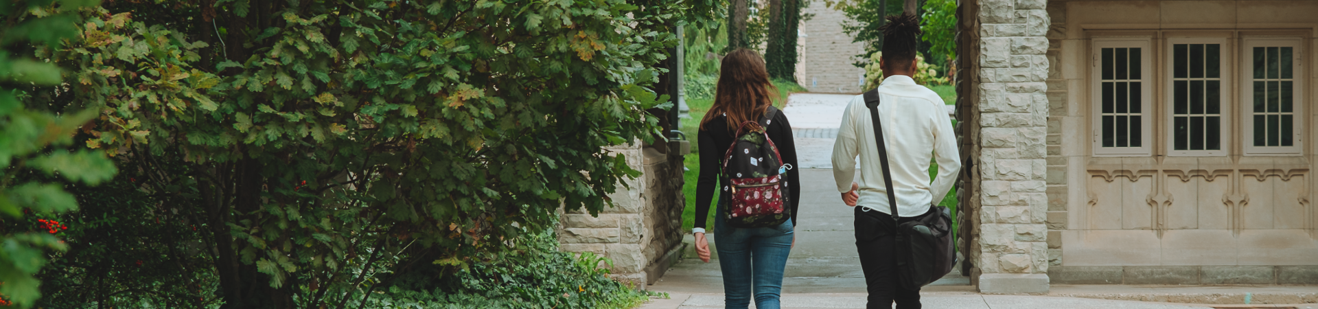 Two people walking on campus.